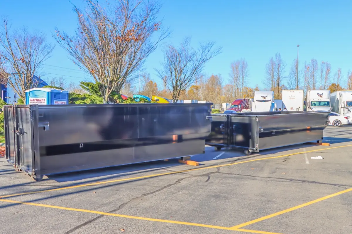 Professional dumpster rental service with roll-off container on residential driveway in Iowa Park